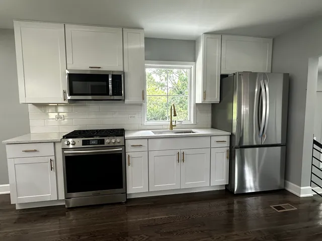 a kitchen with a sink stove and refrigerator