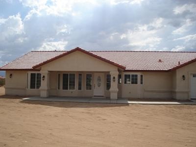 13172 Pacific Road Phelan, CA 92371 - Photo 1 of 1 a front view of a house with a yard