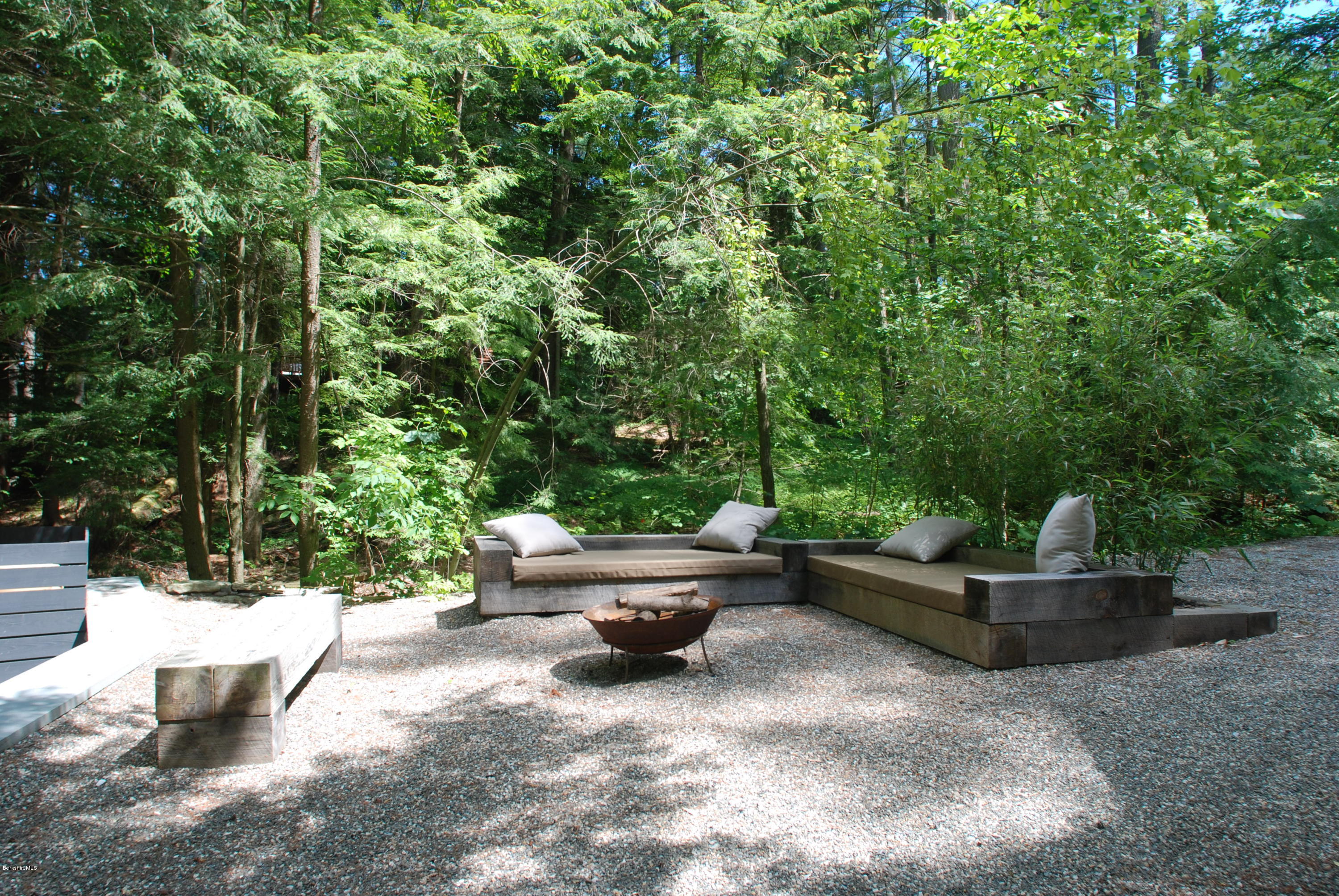 28 Bidwell Road Monterey, MA 01245 - Photo 22 of 28 a backyard of a house with fountain table and chairs