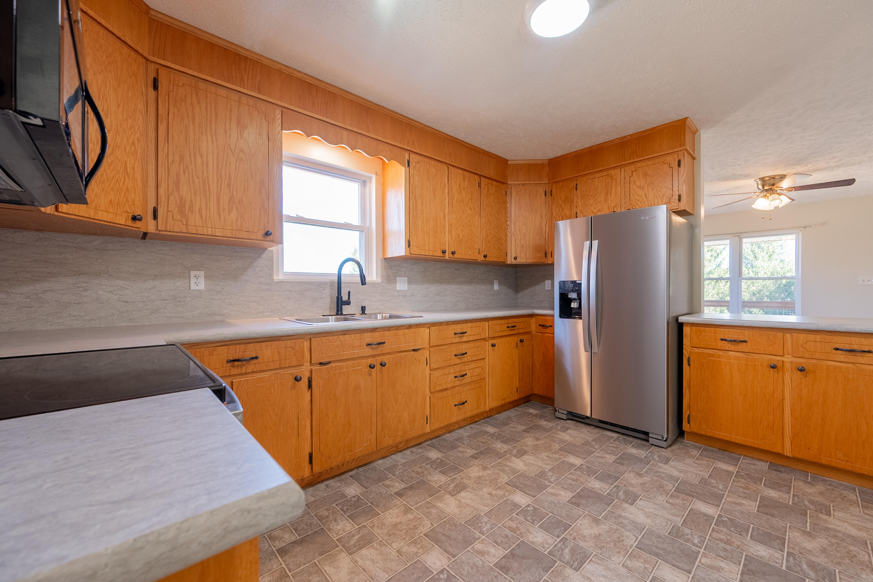 2448 Kyle Weeks Road Southwest Willis, VA 24380 - Photo 18 of 65 a kitchen with stainless steel appliances granite countertop a refrigerator sink and cabinets