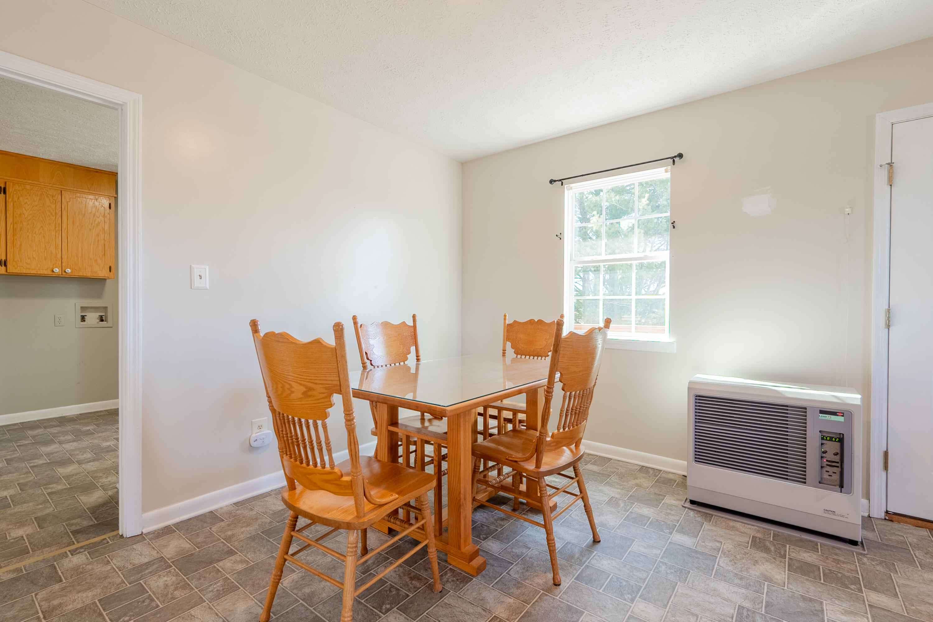 2448 Kyle Weeks Road Southwest Willis, VA 24380 - Photo 21 of 65 a view of a dining room with furniture and window