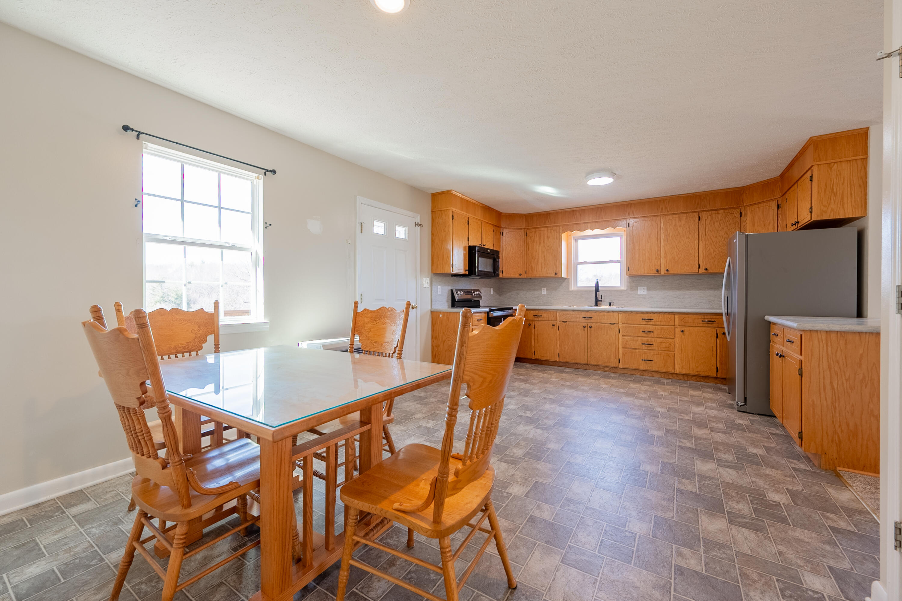 2448 Kyle Weeks Road Southwest Willis, VA 24380 - Photo 22 of 65 a view of a dining room with furniture and a kitchen