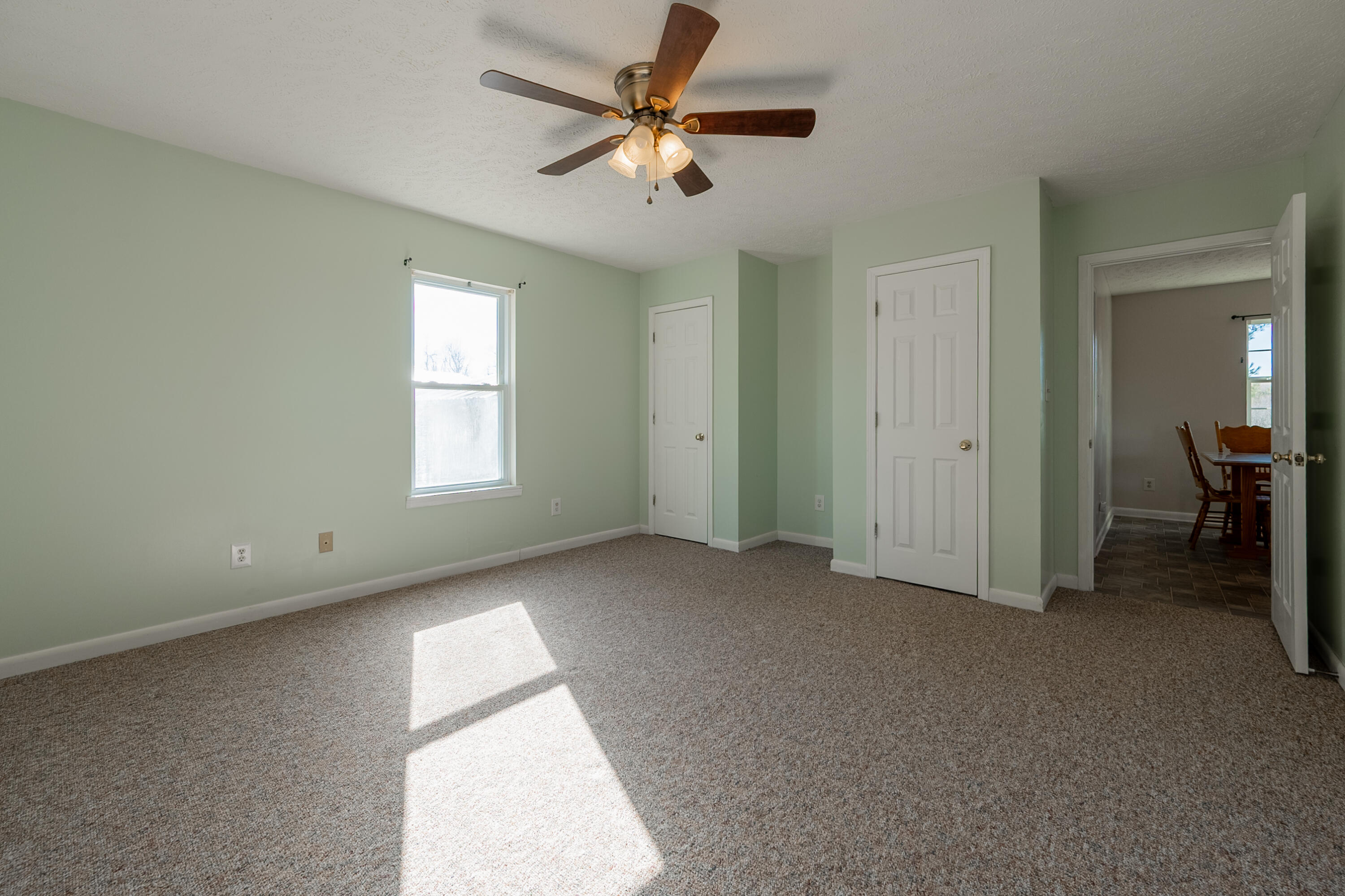2448 Kyle Weeks Road Southwest Willis, VA 24380 - Photo 27 of 65 an empty room with windows and fan