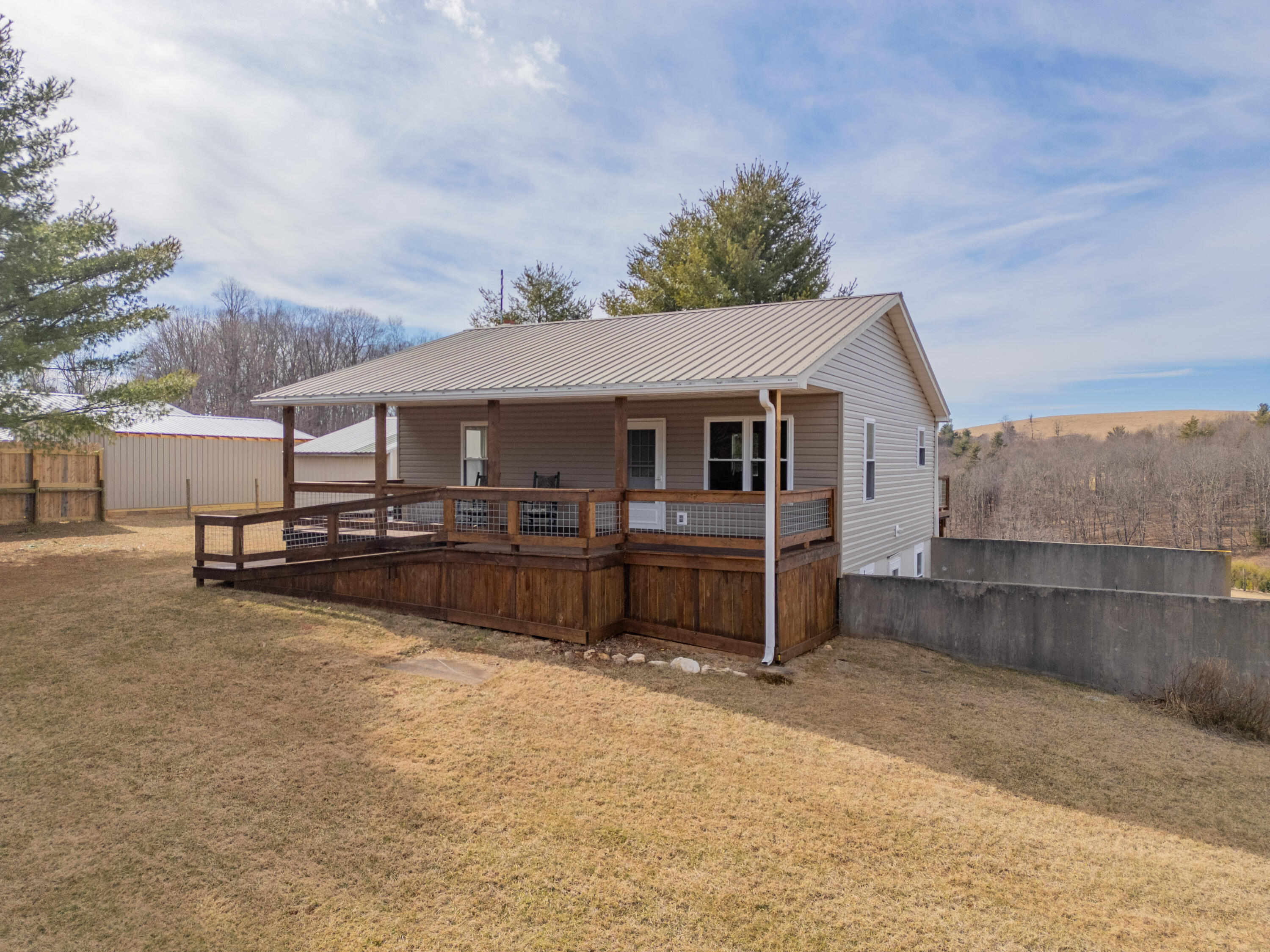 2448 Kyle Weeks Road Southwest Willis, VA 24380 - Photo 3 of 65 a house view with a seating space and deck