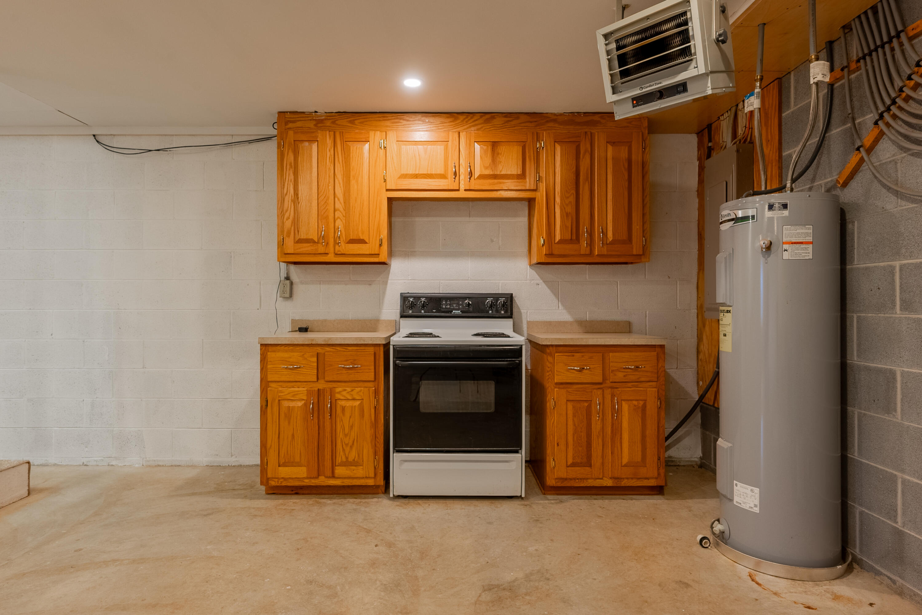 2448 Kyle Weeks Road Southwest Willis, VA 24380 - Photo 35 of 65 a kitchen with stainless steel appliances granite countertop a refrigerator a stove and a sink with wooden cabinets