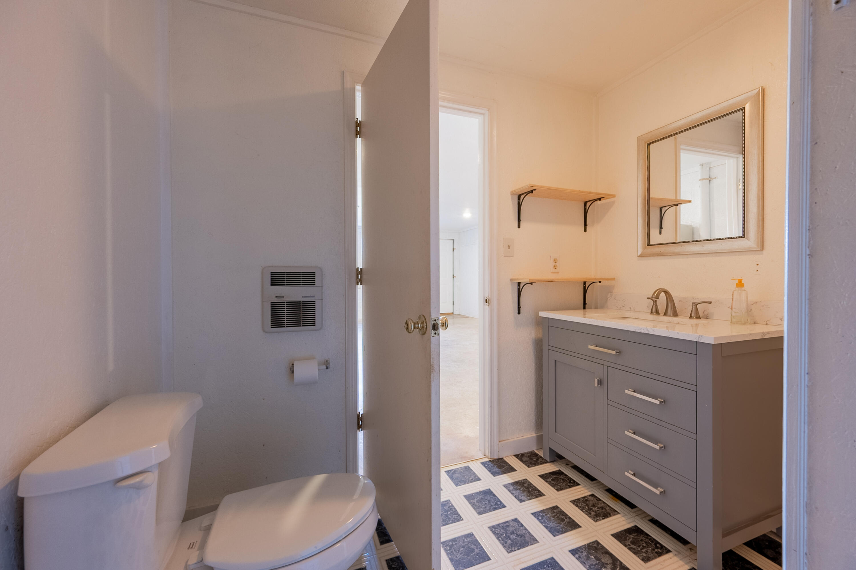 2448 Kyle Weeks Road Southwest Willis, VA 24380 - Photo 45 of 65 a bathroom with a sink a toilet a shower and a mirror