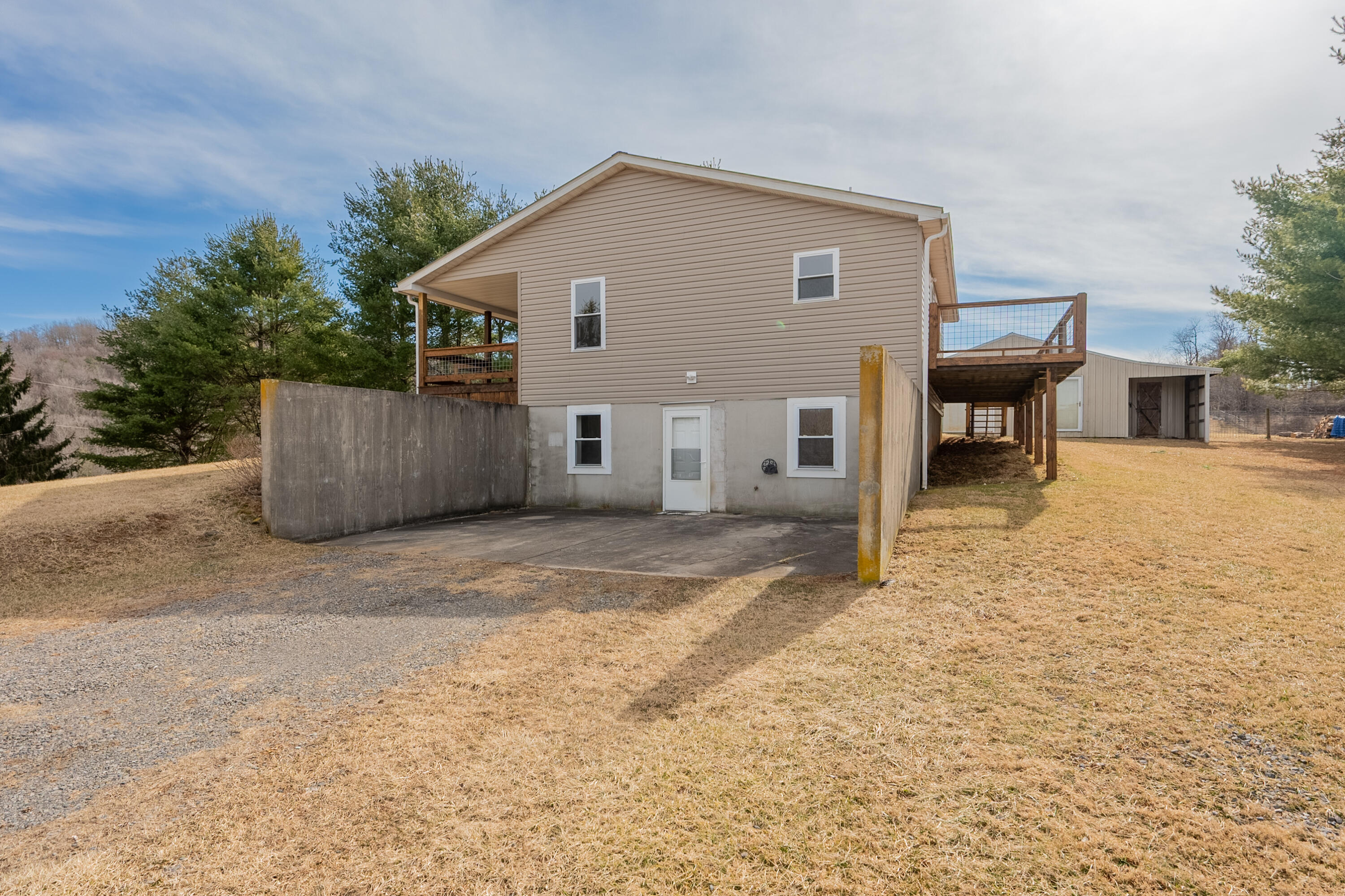 2448 Kyle Weeks Road Southwest Willis, VA 24380 - Photo 54 of 65 a view of a house with a patio and a yard