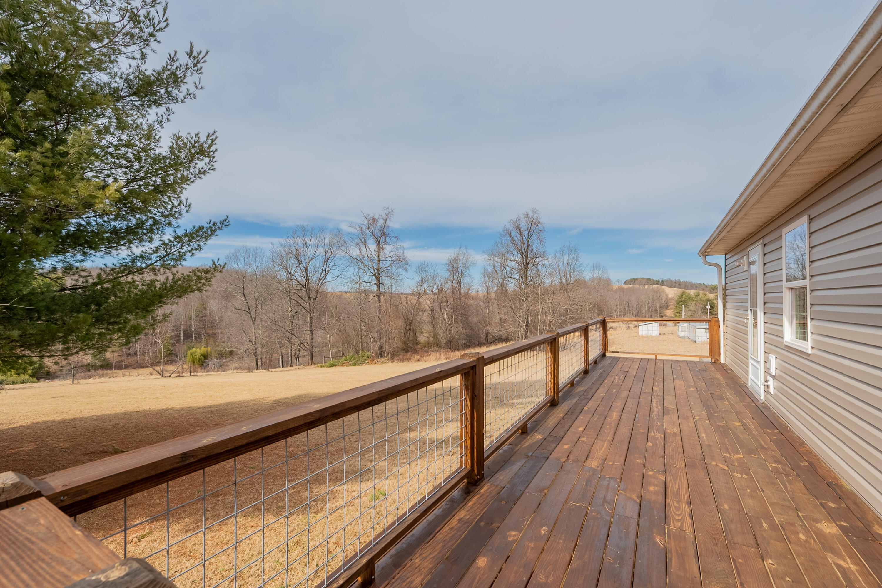 2448 Kyle Weeks Road Southwest Willis, VA 24380 - Photo 56 of 65 a view of balcony with wooden floor and fence