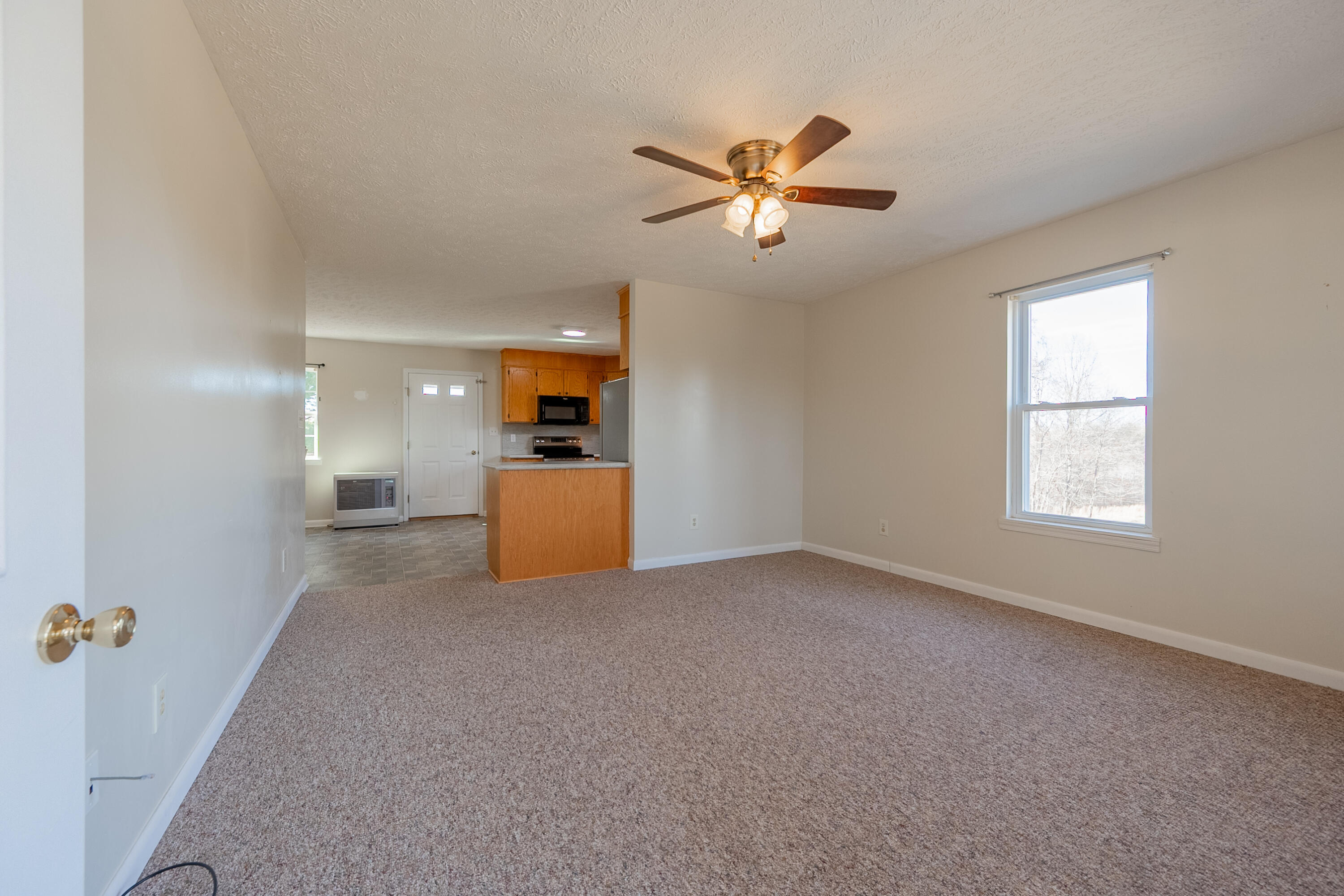 2448 Kyle Weeks Road Southwest Willis, VA 24380 - Photo 10 of 65 a view of a livingroom with a ceiling fan and window