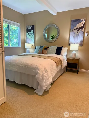 a bedroom with bed and window