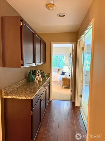 a bathroom with a granite countertop sink a mirror and shower