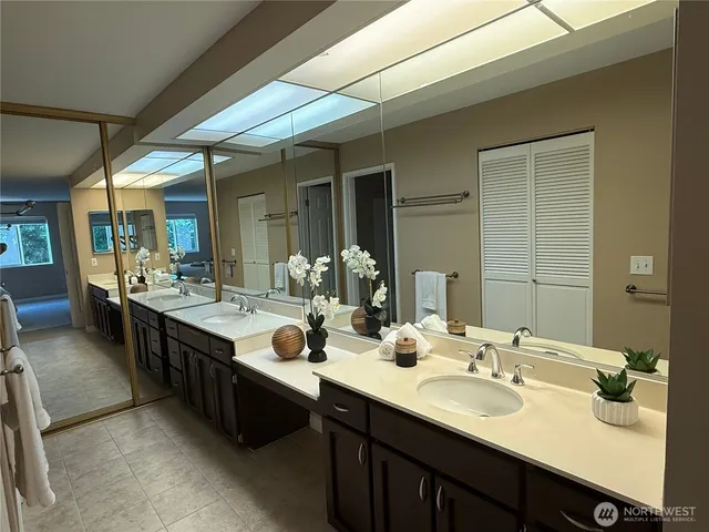 a bathroom with a double vanity sink and a mirror