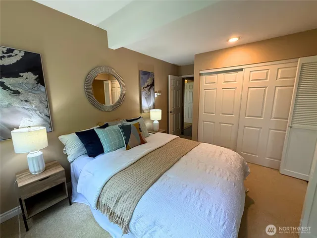 a bedroom with a bed and a lamp