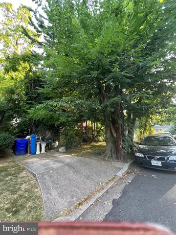 a view of a yard with car parked