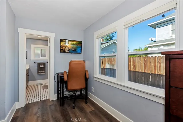 a view of a workspace with furniture and a window