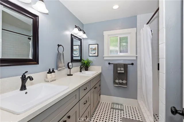 a bathroom with a double vanity sink a and a mirror