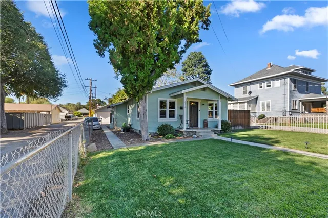 a front view of a house with patio and garden