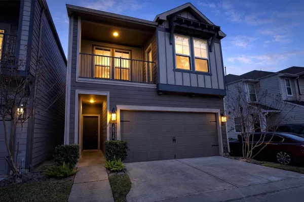 a view of a house with a car park side of road