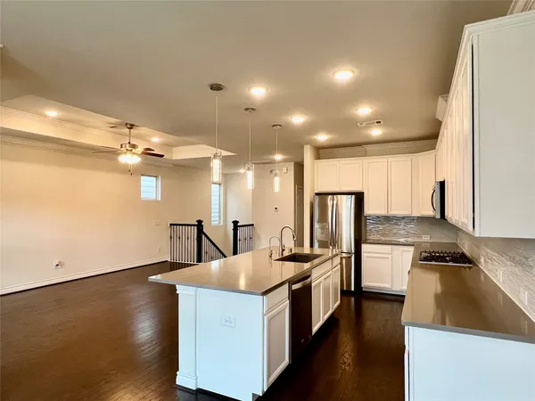an empty room with a window and a ceiling fan