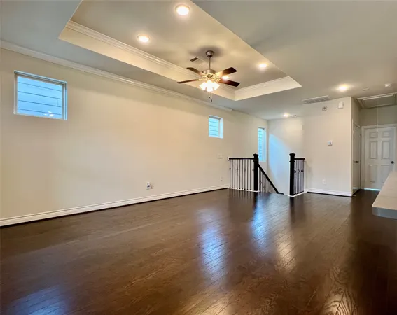 an empty room with a ceiling fan and window