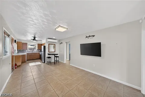 a kitchen with stainless steel appliances granite countertop a refrigerator a sink and a stove
