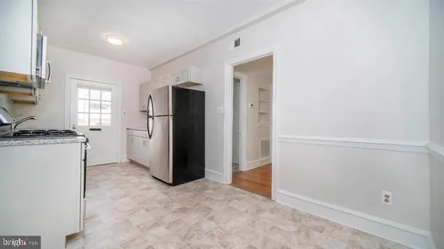 a kitchen with a refrigerator and a stove
