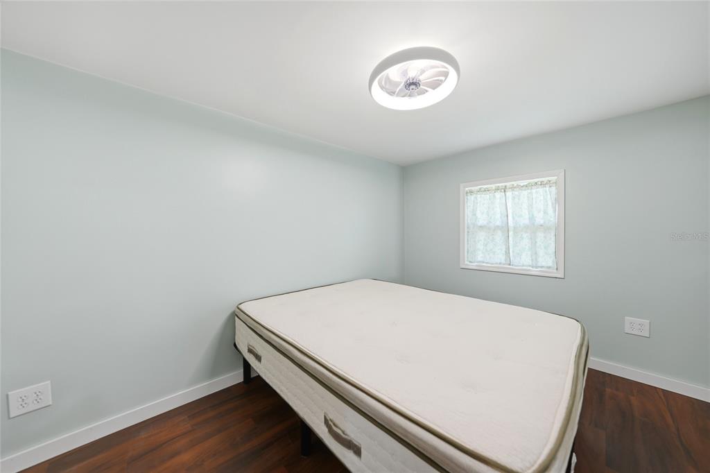 8164 Archie Street Englewood, FL 34224 - Photo 16 of 42 a room with a bed and a window