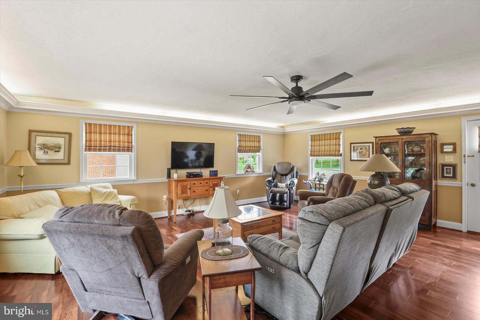 124 Lexington Road York, PA 17402 - Photo 9 of 56 a living room with furniture a ceiling fan a fireplace and a window