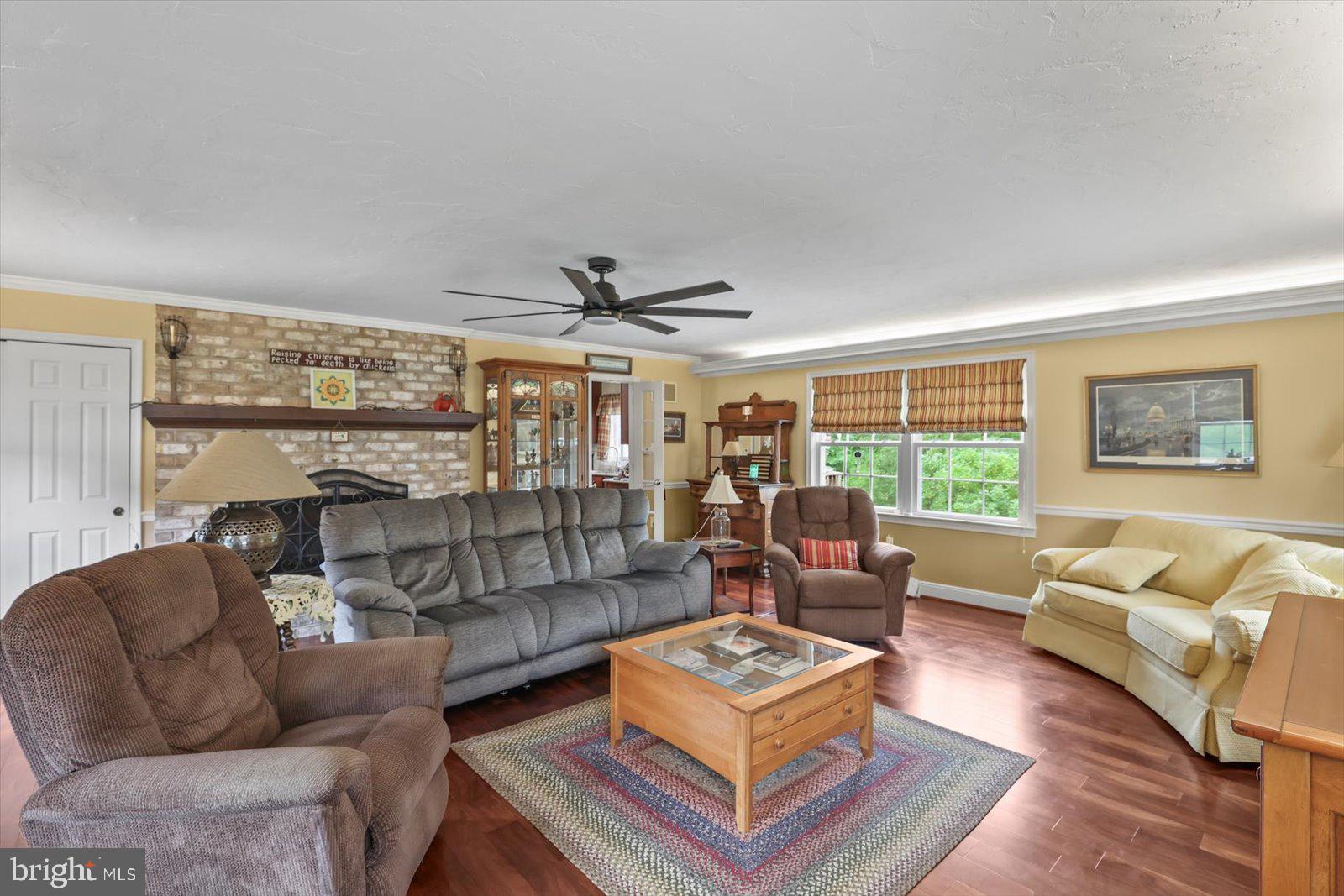 124 Lexington Road York, PA 17402 - Photo 10 of 56 a living room with furniture a ceiling fan and a large window