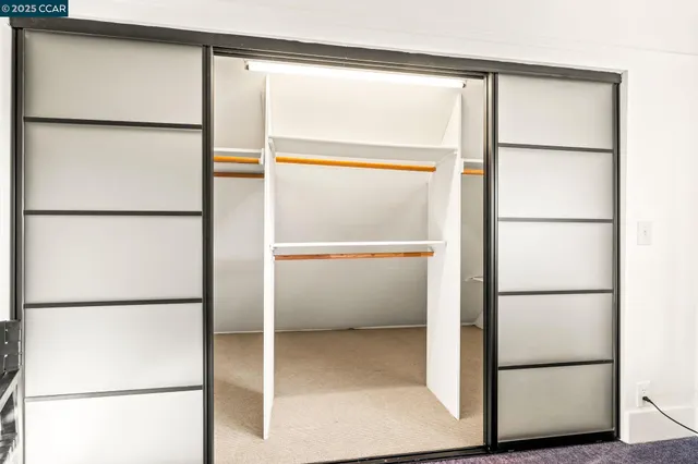 a spacious bedroom with a bed and a window