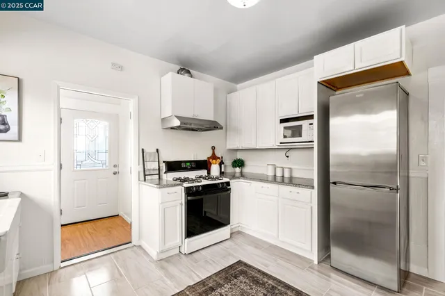 a kitchen with stainless steel appliances a refrigerator stove and sink