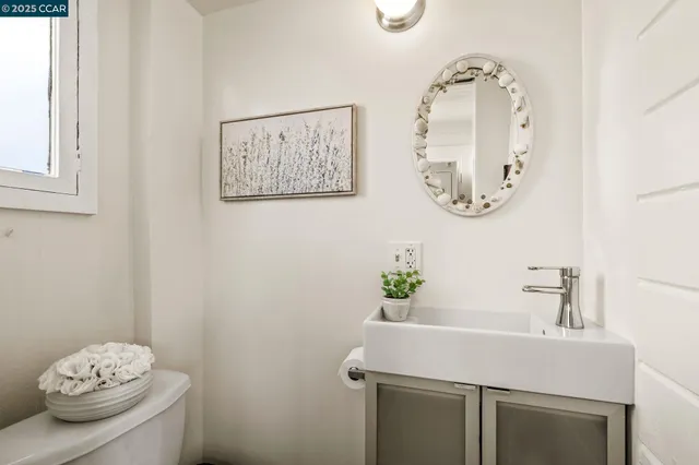 a bathroom with a sink mirror and vanity