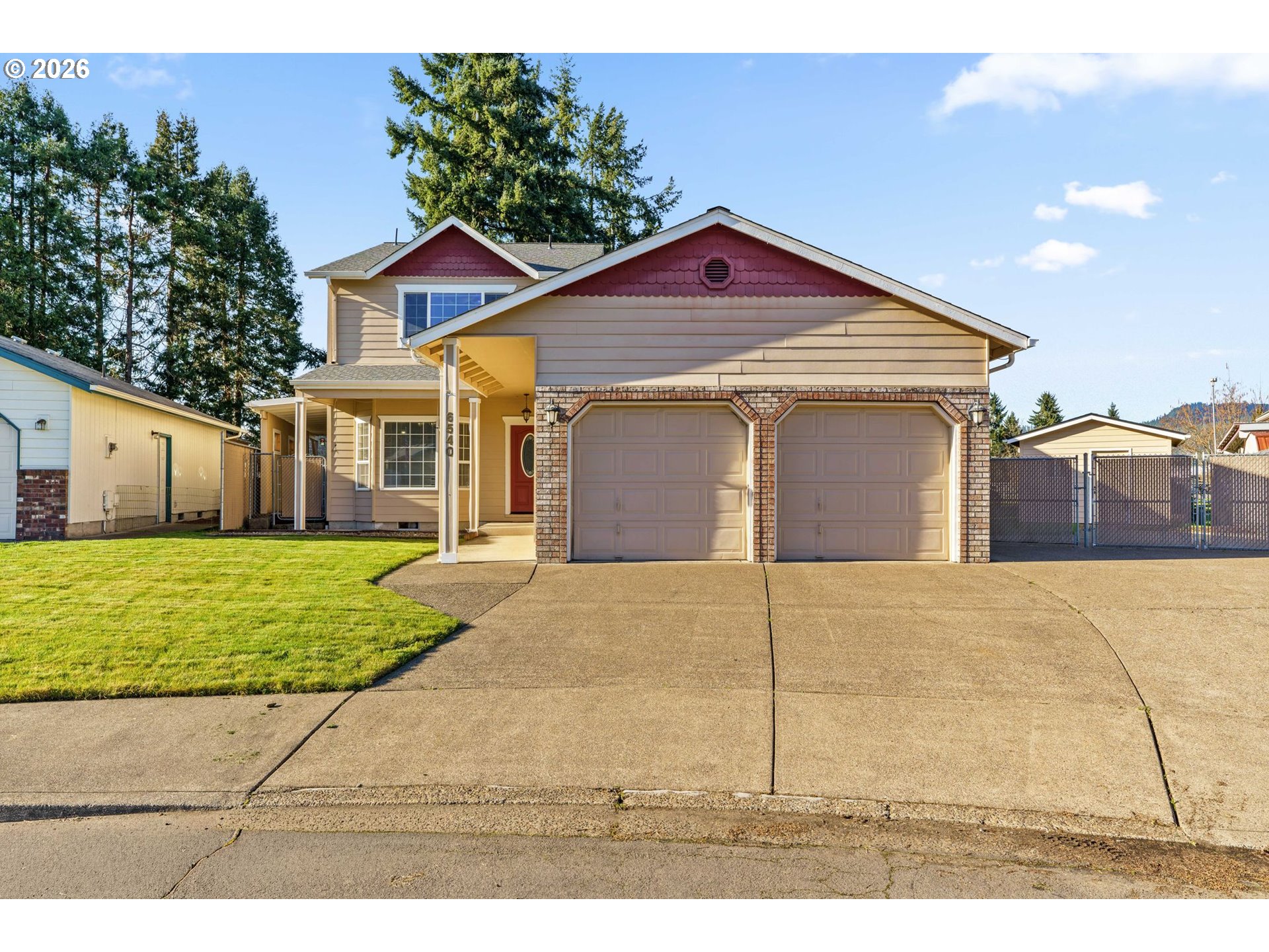 6540 B Street Springfield, OR 97478 - Photo 1 of 48 a view of a yard in front of a house with a large tree