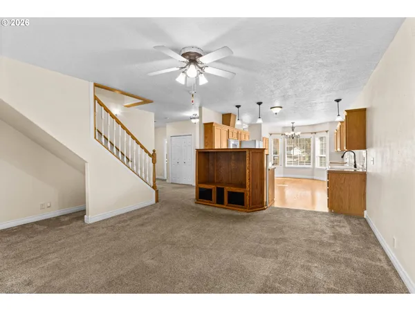 a living room with stainless steel appliances kitchen view and living room view