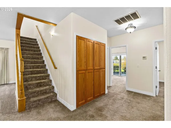 a view of a livingroom with wooden floor and stairs