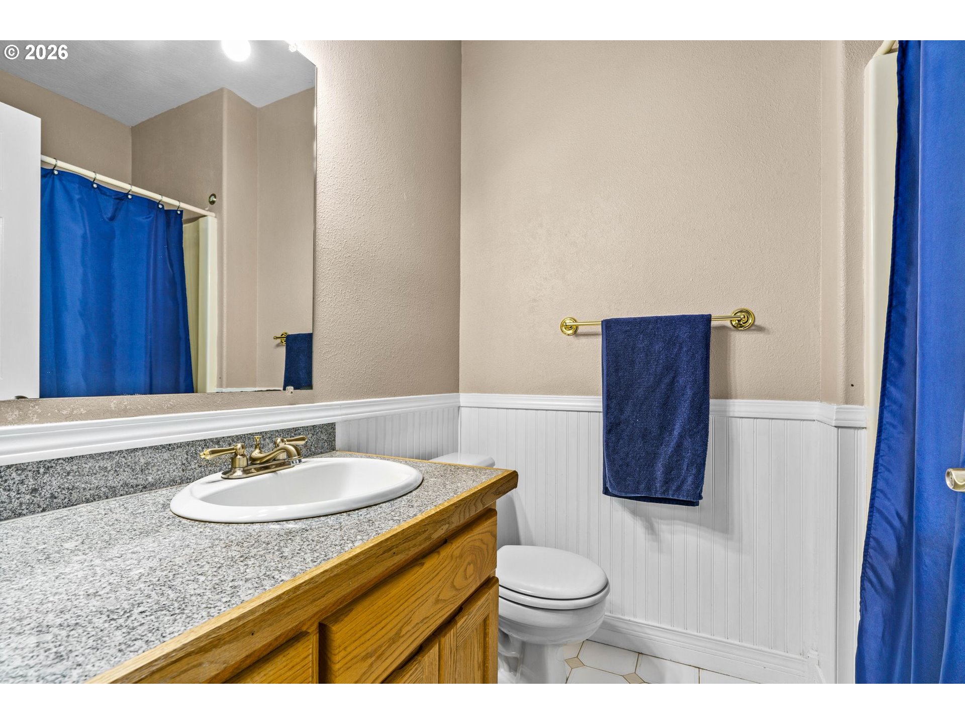 6540 B Street Springfield, OR 97478 - Photo 21 of 48 a bathroom with a granite countertop sink a toilet and a mirror