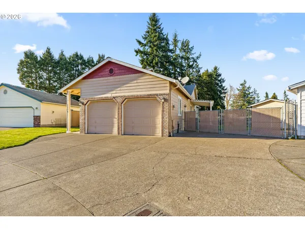 a view of a house with a yard and garage