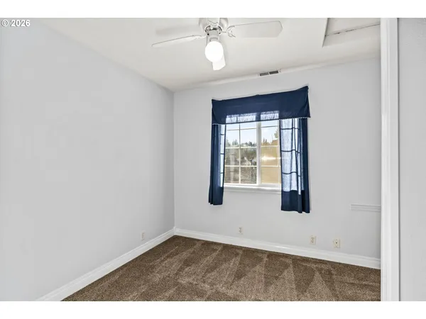 a view of a hallway with a dining room