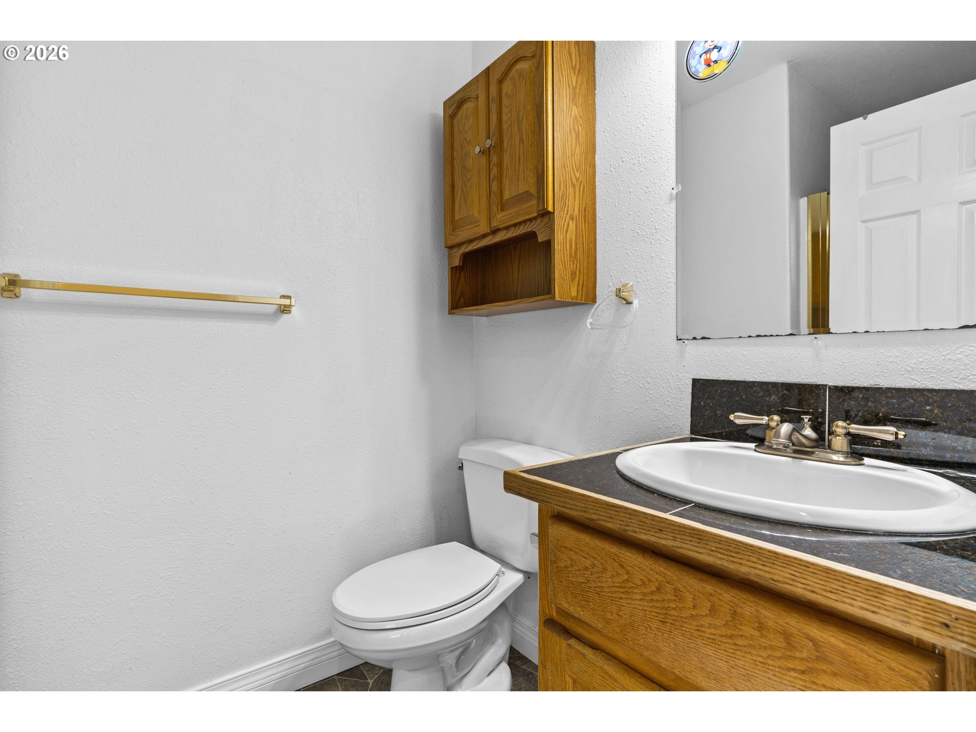 6540 B Street Springfield, OR 97478 - Photo 37 of 48 a bathroom with a sink mirror vanity and toilet
