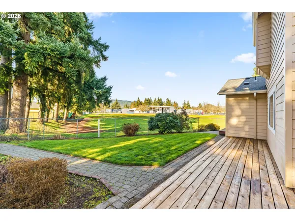 a view of a backyard of a house with many windows