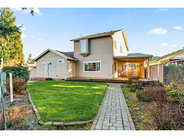a view of backyard with deck and garden