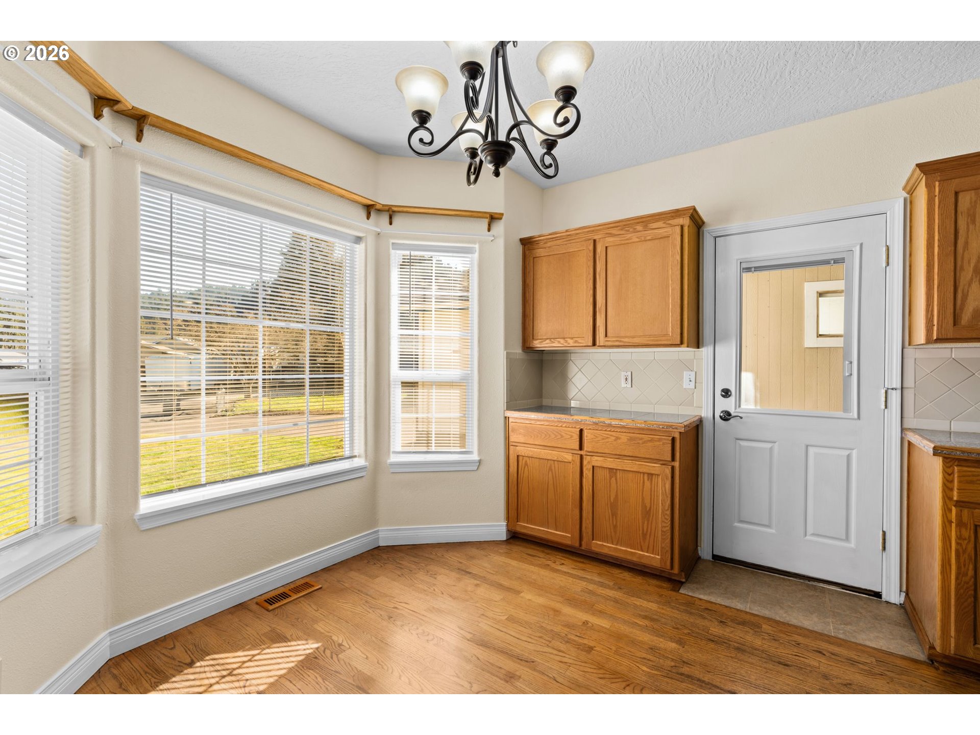 6540 B Street Springfield, OR 97478 - Photo 7 of 48 a kitchen with granite countertop a sink cabinets stainless steel appliances and a large window
