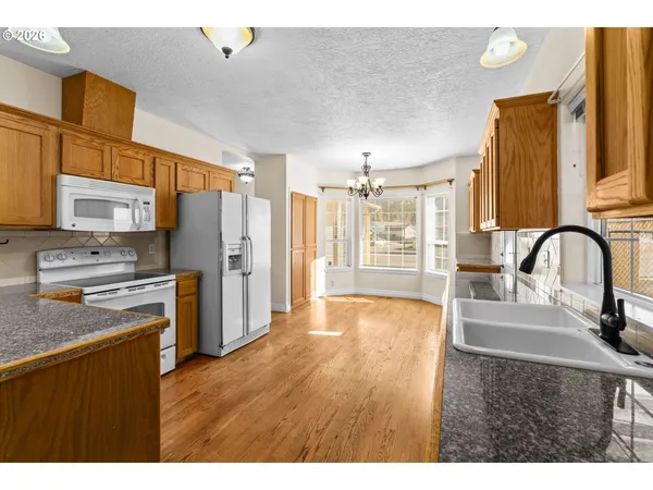 a kitchen with stainless steel appliances granite countertop a refrigerator and a sink