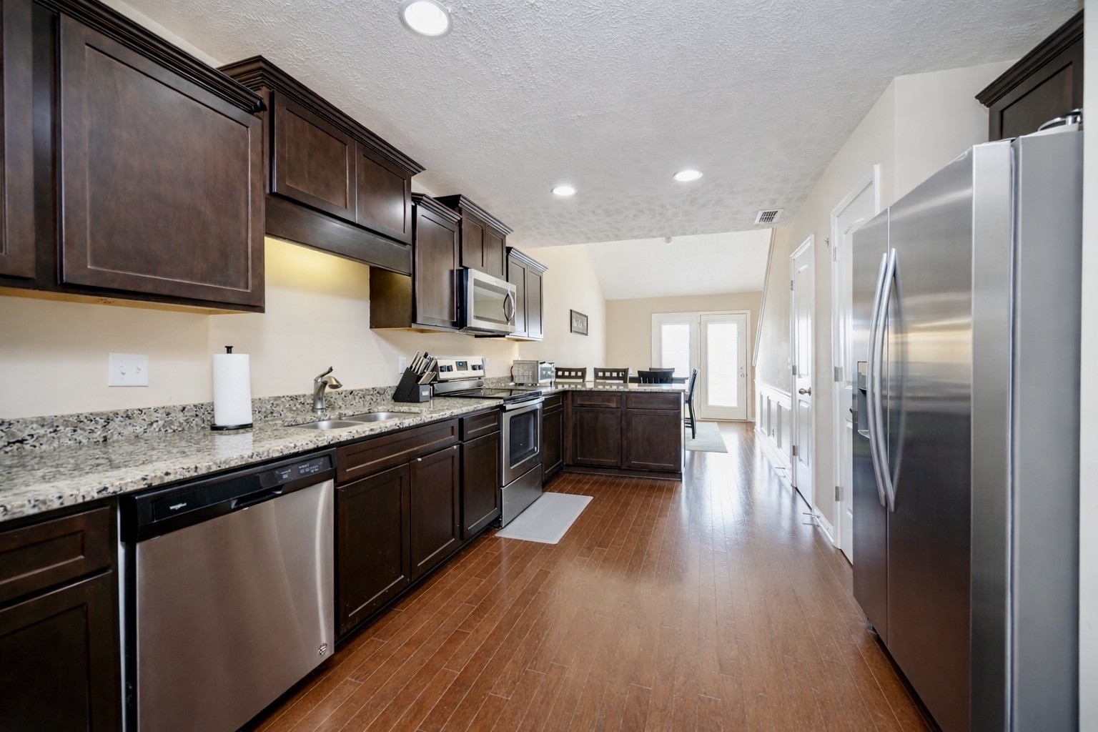 3448 Risen Star Drive Murfreesboro, TN 37128 - Photo 4 of 19 a large kitchen with stainless steel appliances kitchen island granite countertop a stove a sink dishwasher and a refrigerator