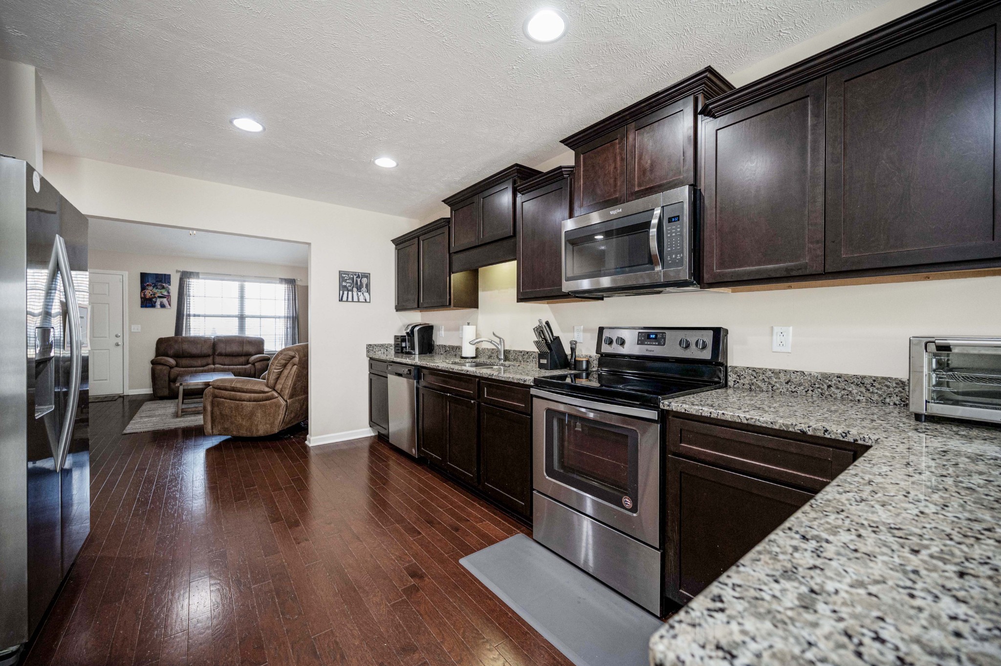 3448 Risen Star Drive Murfreesboro, TN 37128 - Photo 5 of 19 a kitchen with stainless steel appliances granite countertop wooden cabinets a sink dishwasher a stove and a refrigerator with wooden floor