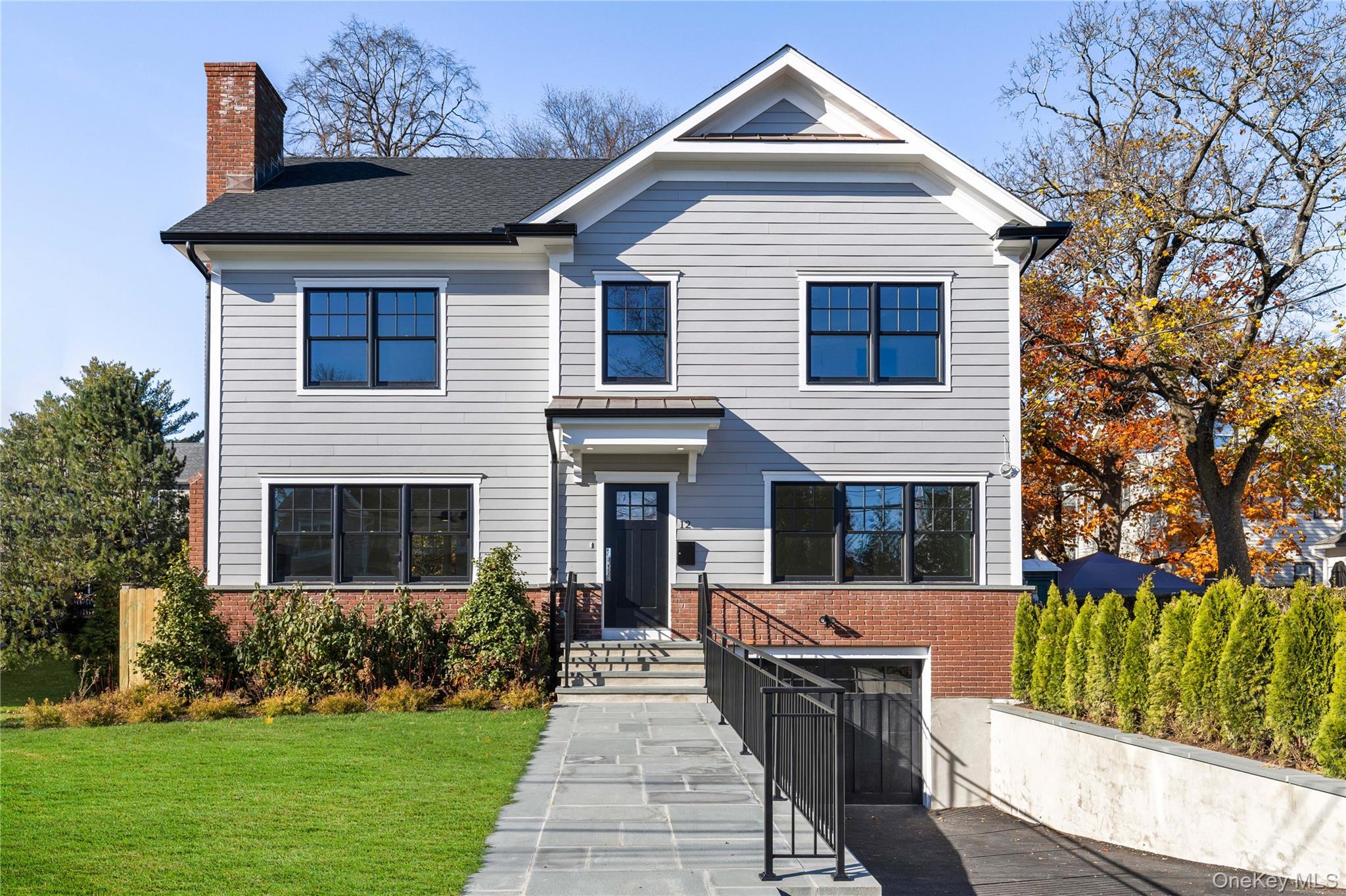 a front view of a house with garden