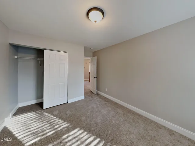 a view of a room with wooden floor and window