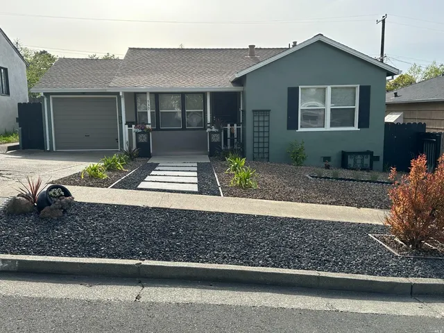 a front view of a house with garden