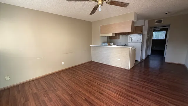 a view of kitchen with wooden floor electronic appliances and window
