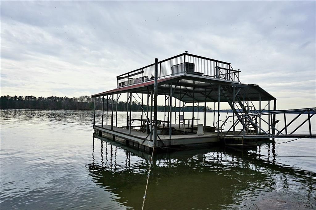 1739 West Green Road Buford, GA 30518 - Photo 2 of 8 a view of a roof deck with lake view and wooden floor